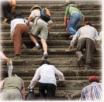 ABOVE Tourists climbing the stairs to the upper level of Angkor Wat, Cambodia