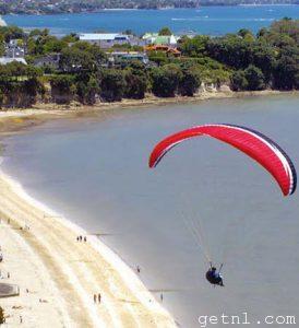 Hang-glider’s-eye-view of the idyllic setting and tranquil waters of Cheltenham Beach, Auckland, New Zealand