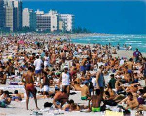 ABOVE Miami Beach, lined with high-rises and barely visible for the crowds of vacationers on its sands