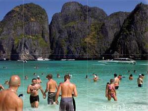 ABOVE Vacationers flock into the azure waters of Maya Bay on Ko Phi Phi, while tour boats buzz back and forth