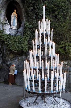 Candles lit by visitors to the Shrine of St Bernadette in Lourdes