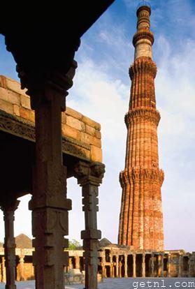 Elaborately carved, tapering Qutb Minar, viewed from the Quwwat-ul- Islam Mosque in the complex, India