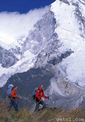 Hikers in Peru’s Cordillera Blanca, with a snowcapped mountain peak in the background