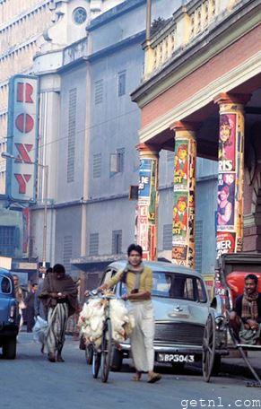 Rickshaw driver waiting for fares outside the Roxy cinema, Kolkata