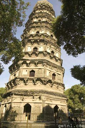 Strikingly ornate Huqiu Tower, rising magnificently above the lush landscape of Tiger Hill Gardens, China