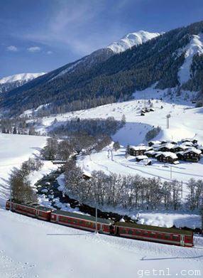 The Glacier Special Express traveling through the frozen winter landscape of Blitzingen village, Switzerland