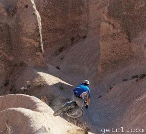 Mountain biker on a daring downhill run near Ürgüp, Cappadocia