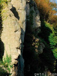 Dramatic limestone cliffs riddled with caves and crevices, typical of the scenery at Creswell Crags, UK