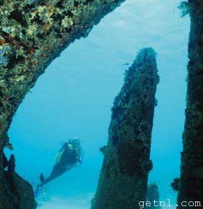 Diver exploring the wrecked steam freighter off Pemba