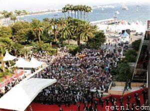 ABOVE Crowds swarming to catch a glimpse of arrivals on the red carpet at the Cannes Film Festival