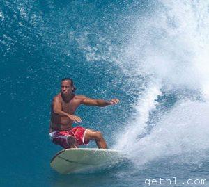 Surfer riding a large, perfectly formed wave, the Soup Bowl, Barbados