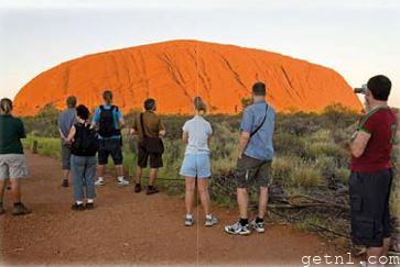 ABOVE A tour group at Uluru, Australia