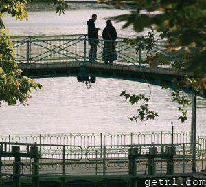 A couple on a bridge over the Canal St-Martin at dusk